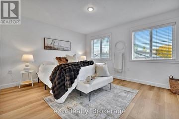 North Perth (Listowel) fourplex for rent - A living room with a white couch and a painting on the wall.