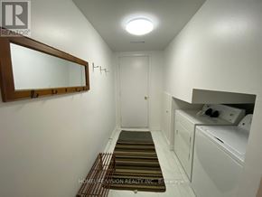 Toronto (Don Valley Village) apartment for rent - A hallway with a white door and a mirror on the wall.