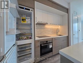 Toronto (Bayview Village) condo for rent - A kitchen with a refrigerator, oven, and cabinets.