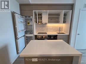 Toronto (Bayview Village) condo for rent - A kitchen with a refrigerator, oven, and sink.