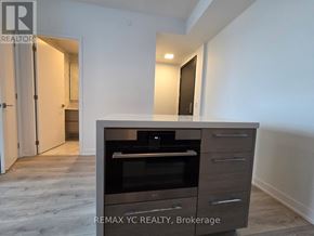 Toronto (Bayview Village) condo for rent - A modern kitchen with a built-in oven and microwave.