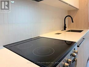 Toronto (Centennial Scarborough) condo for rent - A modern kitchen with a stove top oven and a sink.