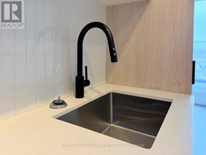 Toronto (Centennial Scarborough) condo for rent - A modern kitchen sink with a black faucet.