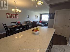 Ajax (South East) apartment for rent - A kitchen with a marble countertop and a bowl of fruit on it.