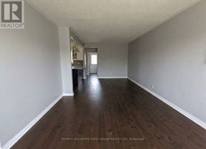 Ajax (South East) apartment for rent - A long, empty hallway with wood floors and white walls.
