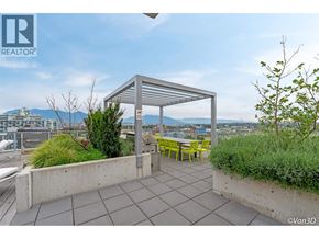Vancouver apartment for rent - A patio with a table and chairs overlooking a cityscape.