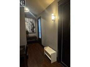 Richmond apartment for rent - A hallway with a bench and a realtor sign.