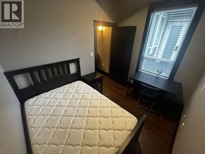 Richmond apartment for rent - A bedroom with a bed, desk, and chair.