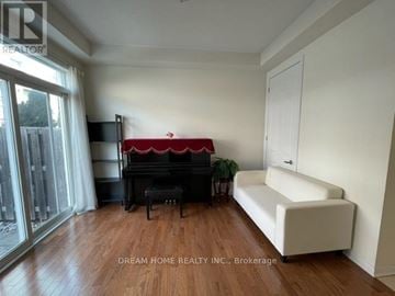 Toronto (Clairlea-Birchmount) townhouse for rent - A living room with a red couch and a white sofa.
