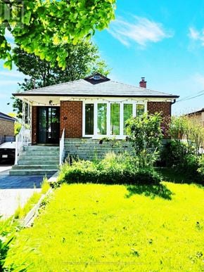 Toronto (Wexford-Maryvale) apartment for rent - A small house with a green lawn in front.