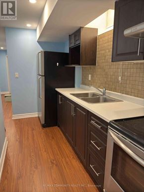 Markham (Cedarwood) apartment for rent - A kitchen with a black fridge and wooden floors.