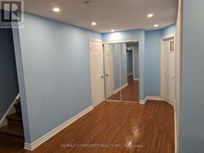 Markham (Cedarwood) apartment for rent - A hallway with white doors and wooden floors.