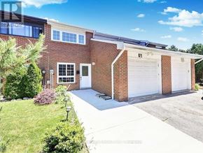 Toronto (Malvern) townhouse for rent - A house with a garage and solar panels on the roof.