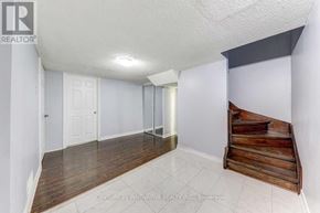 Toronto (Malvern) townhouse for rent - A room with a white ceiling, wooden floor, and a wooden bench.
