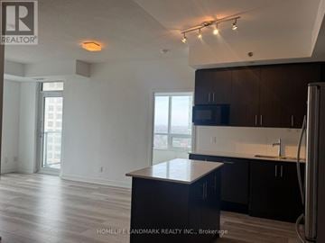 Toronto (Tam O'shanter-Sullivan) condo for rent - A kitchen with a black counter top and a refrigerator.