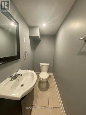 Toronto (Rouge) apartment for rent - A bathroom with a toilet, sink and mirror.