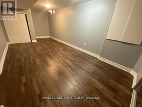 Toronto (Rouge) apartment for rent - A room with wooden flooring and a white wall.