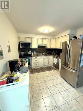 Hamilton (Randall) townhouse for rent - A kitchen with a refrigerator, microwave, and oven.