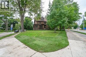 Kitchener apartment for rent - A house with a lawn in front of it.