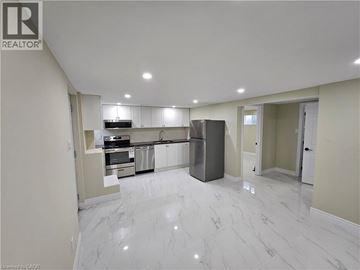 Kitchener apartment for rent - A spacious kitchen with white marble flooring and modern appliances.