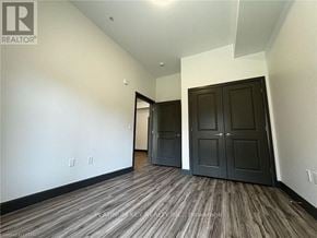 Strathroy-Caradoc (Mount Brydges) townhouse for rent - A room with a wood floor and a wall with switches.