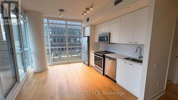 Toronto (Mount Pleasant West) condo for rent - A kitchen with white cabinets and a wooden floor.
