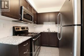 Toronto (Dovercourt-Wallace Emerson-Junction) condo for rent - A kitchen with a refrigerator, oven, and microwave.