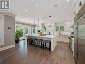 Halton Hills (Rural Halton Hills) apartment for rent - A modern kitchen with white cabinets and a wooden floor.