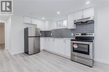 Waterloo apartment for rent - A modern kitchen with white cabinets and stainless steel appliances.