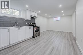 Waterloo apartment for rent - A kitchen with white cabinets and a grey floor.