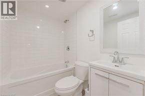 Waterloo apartment for rent - A white bathroom with a toilet, sink, and tub.