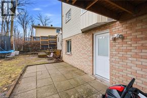 Kitchener apartment for rent - A backyard with a patio and a small garden.