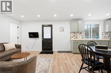 Kitchener apartment for rent - A modern living room with a brown sofa and a wooden coffee table.