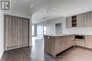 Toronto (Bayview Village) condo for rent - A modern kitchen with wooden cabinets and a large island.