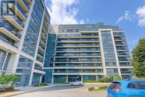 Richmond Hill (Doncrest) condo for rent - A blue car is parked in front of a large apartment building.