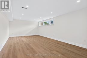 Toronto (Eringate-Centennial-West Deane) apartment for rent - A spacious room with wooden flooring and white walls.
