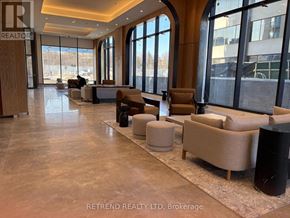 Toronto (Don Valley Village) condo for rent - A large, well-lit lobby with a marble floor and seating area.