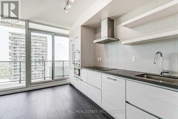 Toronto (Mount Pleasant West) condo for rent - A modern kitchen with white cabinets and a stainless steel sink.