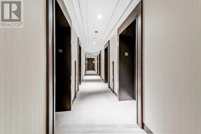 Toronto (Mount Pleasant West) condo for rent - A long hallway with doors on both sides and a number 56 on the wall.