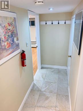 Toronto (Yonge-Eglinton) triplex for rent - A hallway with a fire extinguisher on the wall.