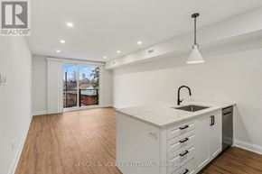 Ottawa apartment for rent - A kitchen with white cabinets and a sink is shown in the image.
