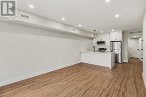 Ottawa apartment for rent - A large, empty room with wooden floors and white walls.