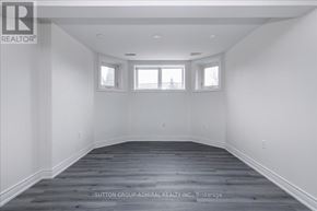 Barrie (Holly) apartment for rent - A spacious room with wooden flooring and white walls.