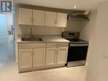 Toronto (Dovercourt-Wallace Emerson-Junction) apartment for rent - A kitchen with white cabinets and a stainless steel dishwasher.