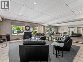 Windsor condo for rent - A living room with black furniture and a large window.