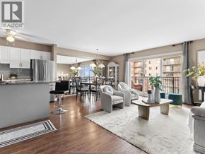 Windsor condo for rent - A well-lit living room with a kitchen area in the background.