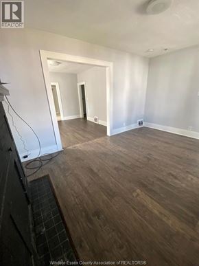 Windsor apartment for rent - A room with wooden flooring and white walls.
