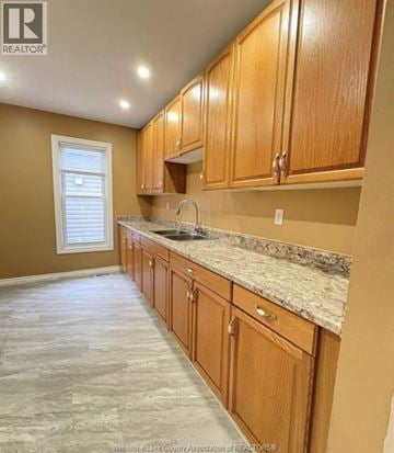 Windsor apartment for rent - A kitchen with wooden cabinets and granite countertops.