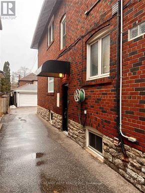 Toronto (Yonge-Eglinton) apartment for rent - A red brick building with a black awning and a white garage door.