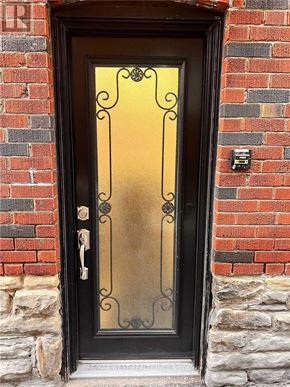 Toronto (Yonge-Eglinton) apartment for rent - A black door with a glass panel and a metal handle.